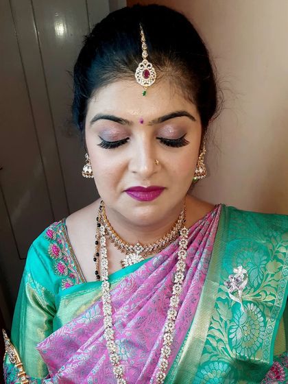 A close-up of the shimmery pink eyeshadow and perfectly defined lashes for the housewarming party look. This shows how a touch of sparkle can elevate the entire look.