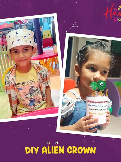 Two children proudly show off the DIY alien crowns they created. Our space adventure is full of fun, imaginative crafts that they can take home.