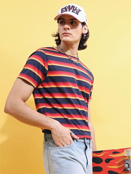 A nod to 80s and 90s skater style. I styled this striped tee with light-wash jeans, a baseball cap, and a skateboard prop to create a nostalgic, Stranger Things-inspired look.