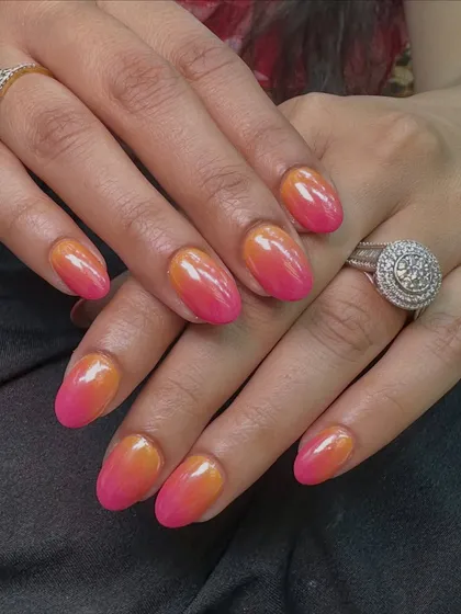 This is a vibrant sunset ombre effect with a chrome finish. The colors blend seamlessly from a bright orange to a hot pink for a fun, summery vibe.