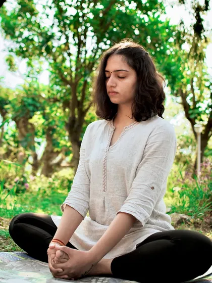 Mindfulness is at the heart of my teaching. Here, I am in a moment of quiet meditation, practicing Baddha Konasana (Bound Angle Pose) in a peaceful mountain setting. I guide my students to use breath as an anchor to find this same sense of gratitude and inner calm.