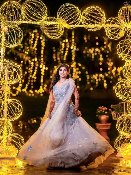 Every bride deserves to feel like she's in a fairytale. Using a backdrop of beautiful string lights, we created this magical bridal portrait that feels dreamy and full of sparkle, perfect for a sangeet night.