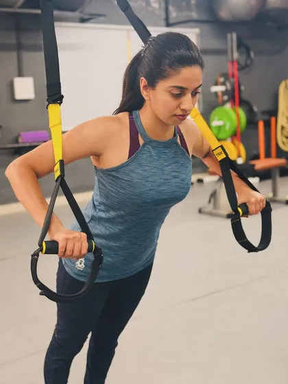 Strength training is for everyone. Here, I am demonstrating a TRX push-up, a fantastic exercise for building core and upper body strength safely and effectively.