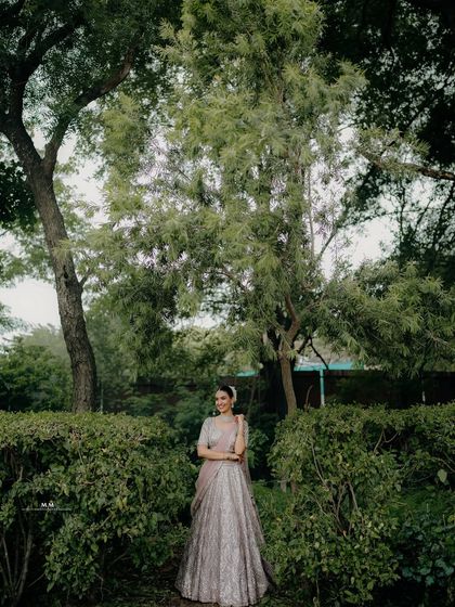 A wide shot capturing the bride in a beautiful garden, her smile as bright as the nature surrounding her.
