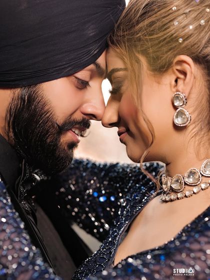 A close-up of the couple, her earrings and necklace sparkling beautifully.