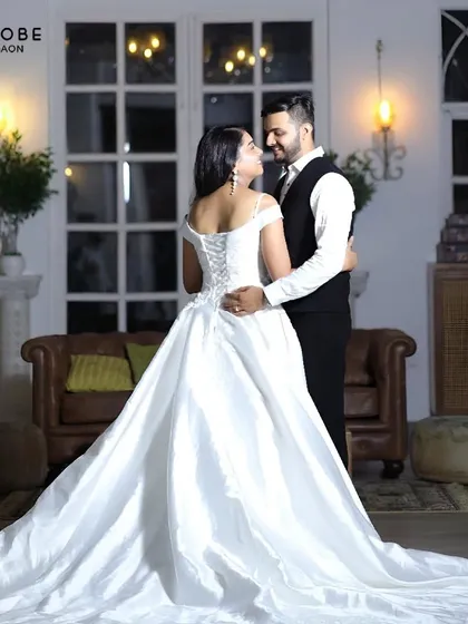 A classic fairytale moment. This white off-shoulder ball gown with a long train is the epitome of romance for a pre-wedding shoot.