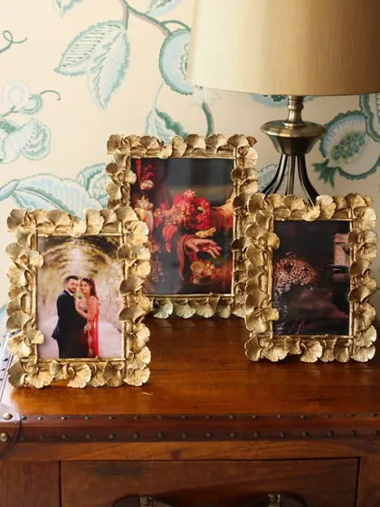 A collection of our golden ginkgo leaf photo frames, styled on a vintage trunk. The intricate leaf design adds a touch of nature-inspired artistry to your most treasured photographs.
