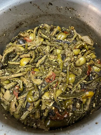 A pot full of 'Rusep' being prepared. This simple, healthy side dish is a staple in Naga homes and a favorite among those who love bold, earthy flavors.