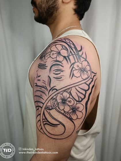This large shoulder piece portrays Lord Ganesha with hibiscus flowers, created entirely with clean line work. It's a modern and elegant take on a traditional symbol of wisdom and obstacle removal.