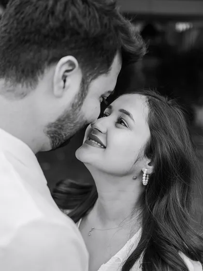 A black and white close-up capturing the look of love between the couple. The tight framing makes this moment feel incredibly personal and intimate.