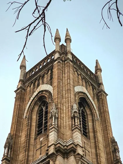 Collecting pieces of history from my hometown, this is a shot of a Gothic church tower against a pale sky.
