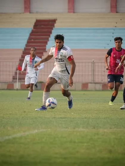A player dribbling past opponents, demonstrating the attacking mindset of the Wolves.