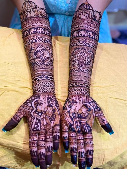 A slightly different angle of the same royal-themed portrait mehandi, showcasing the symmetry and intricate detailing that covers the hands and arms.