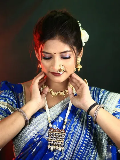 A beautiful shot showing the bride's complete look, from her makeup and hair to her traditional jewelry and saree. This is a perfect example of a classic Maharashtrian bride.