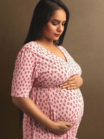A simple, heartfelt portrait focusing on the mom-to-be's connection with her baby bump.