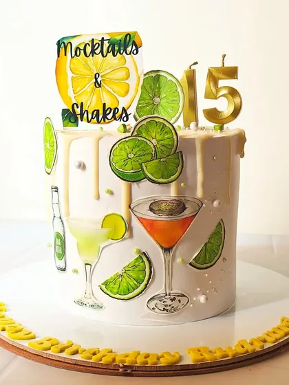 A refreshing mocktails and shakes-themed cake for a 15th birthday. The design is decorated with edible images of lime slices and colorful drinks.