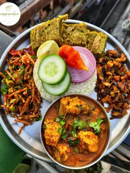 A platter showcasing some unique Manipuri items like Sareng fish, savory paknam cake, yongchak singju, and a salted fish kanghou.