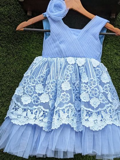 This beautiful blue lace frock is available in sizes for girls from 1 to 9 years old. It's a lovely choice for a birthday or special occasion.