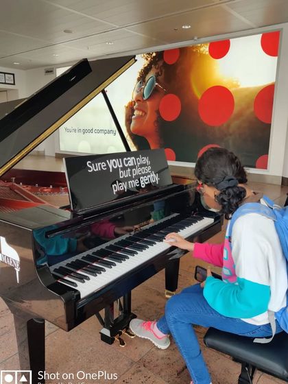 Another student spotted. Here's Kiara taking a moment to practice on a grand piano at the airport during her family's Euro trip.