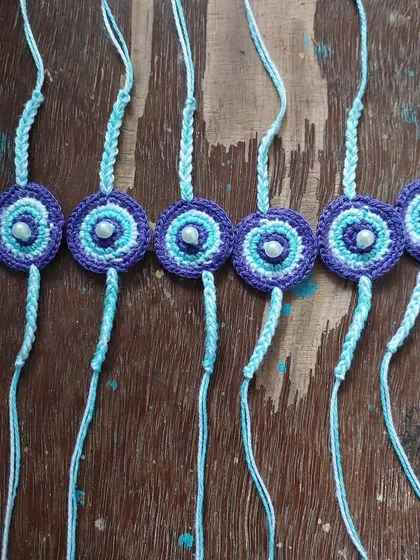 Custom evil-eye themed rakhis, combining traditional symbols with handmade craftsmanship.