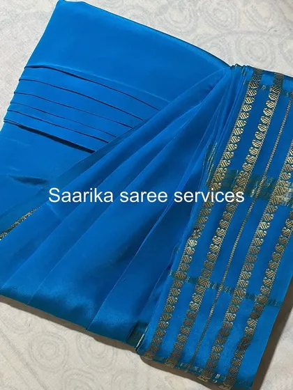 A beautiful chiffon saree in a bright blue color.