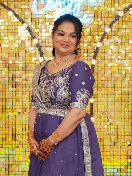A beautiful smile from a happy client. Her makeup features a soft purple smokey eye to match her embroidered Anarkali, perfect for an evening reception.