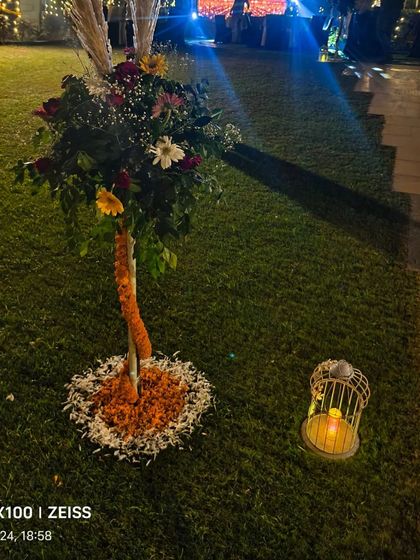 A decorative floral tree prop used to enhance the ambiance of the outdoor Diwali celebration.