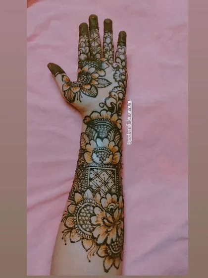 A full-arm design that beautifully combines geometric jaal patterns with large, shaded floral motifs.