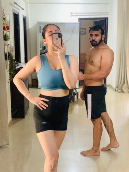 A mirror selfie capturing a moment of our workout. It's great having a partner who shares the same fitness goals. We keep each other motivated.