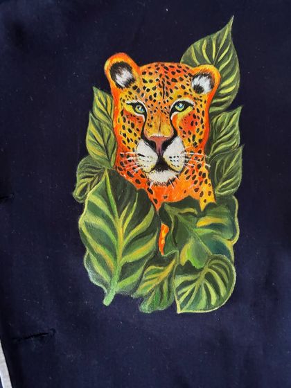 A direct, close-up view of the leopard artwork. This angle highlights the detailed brushwork on the fur, the whiskers, and the shading that gives the animal a realistic and three-dimensional feel.