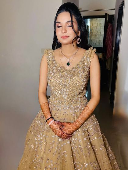 A close-up of the makeup for the golden gown look, featuring soft brown eyeshadow and a winged liner.