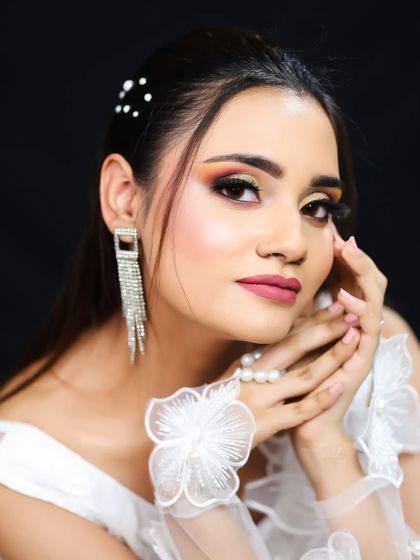 A close-up portrait that captures the warmth and glow of the makeup.