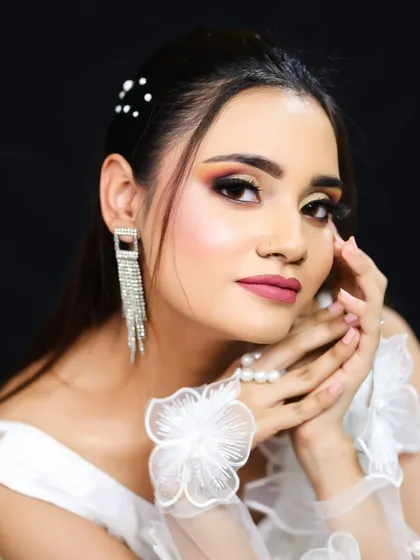 A close-up portrait that captures the warmth and glow of the makeup.