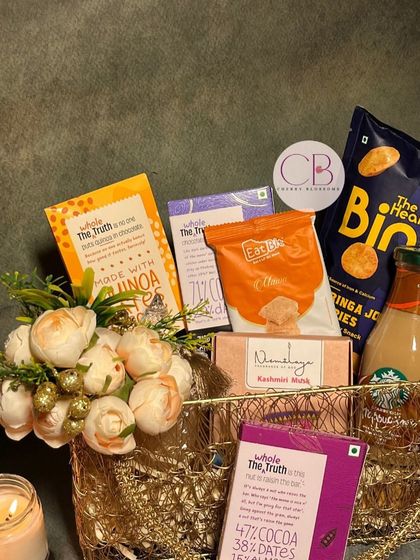 We are crushing over these Diwali hampers. This one features a golden wire basket filled with healthy treats like The Whole Truth chocolates and Binge jowar puffs, along with a Starbucks Frappuccino.