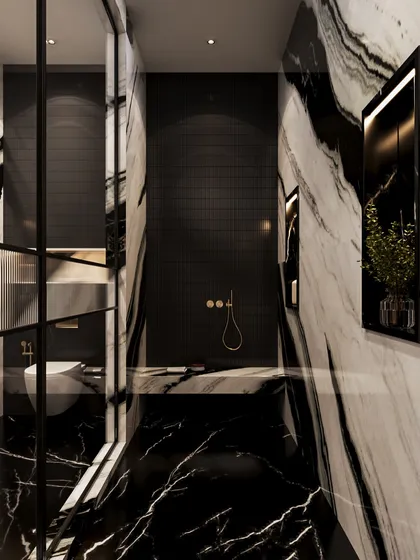 The shower area is a cocoon of black tiles and dramatic marble, creating a dark and intimate atmosphere. The brass fixtures provide a warm, luxurious contrast.