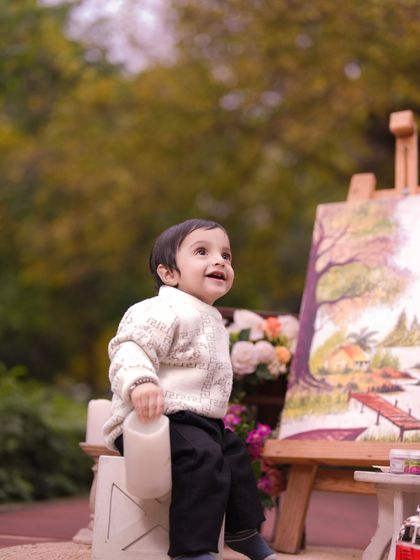 Little giggles, big memories. A candid moment from my 'Little Artist' outdoor session, capturing a child's upward glance of wonder.