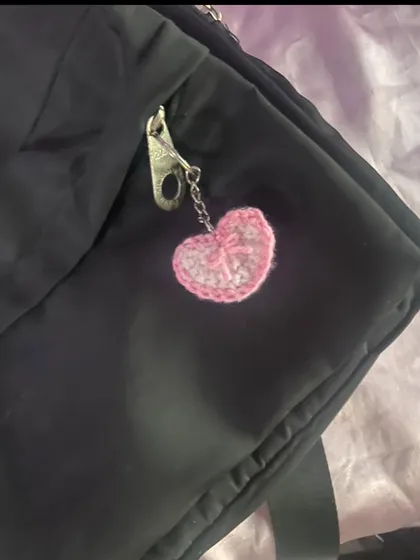 This is my pink crochet heart charm with a little bow detail. It's perfect for adding a soft, girly touch to your keys or bag.