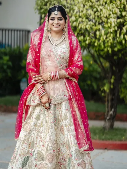 A series showcasing a beautiful sunset wedding look. The bride's makeup is soft and romantic, with a flawless base and defined eyes, perfectly complementing her stunning pastel lehenga for a picturesque Goa wedding.