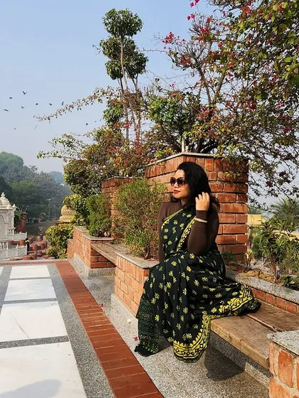 Celebrating Makar Sankranti in a beautiful black and yellow printed saree. The modern draping style with a full-sleeve blouse makes it perfect for a winter festival.