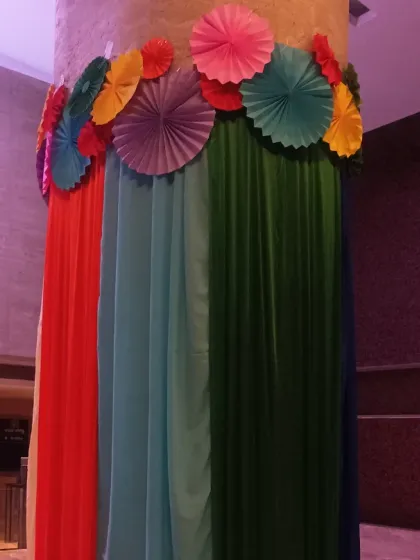 Another view of our pillar decorations for a Holi party. The combination of bright fabrics and handmade paper rosettes adds a touch of handmade charm to the corporate environment.