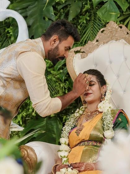 A beautiful portrait of the parents-to-be, framed by the lush greenery and traditional elements of their baby shower decor.