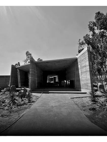 The powerful entrance to one of the resort's main buildings, with its strong lines and raw concrete finish.