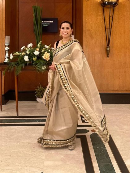 A full-length view of my sister's wedding guest look. The off-white saree paired with a contrasting black blouse creates a sophisticated and modern aesthetic.