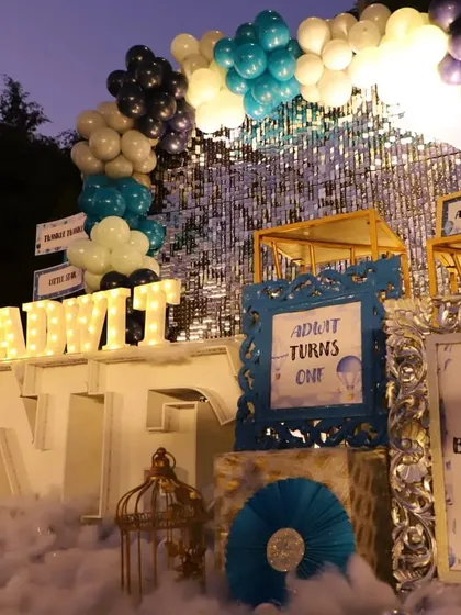 A close-up of the main backdrop, showing the personalized framed signs and decorative birdcage, all part of the intricate "Love You to the Moon & Back" theme.