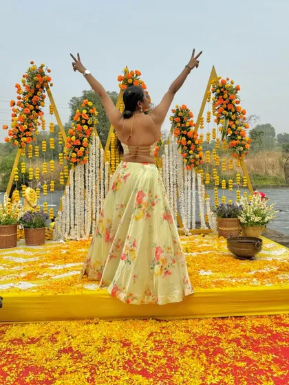 A victory pose in my Haldi outfit, celebrating the beautiful setup and the start of a fun-filled event.