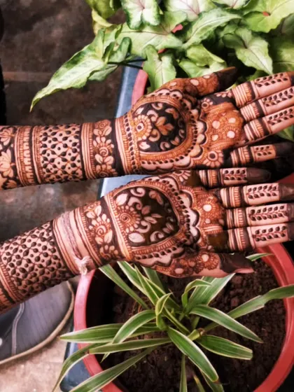This design features a heart-shaped central pattern surrounded by intricate details. The dark fill around the heart makes it the focal point of the palm.