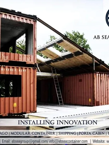 This image captures a multi-story container home during the construction phase. It shows the raw structure before the addition of cladding and interior finishes, revealing the building's strong steel skeleton.