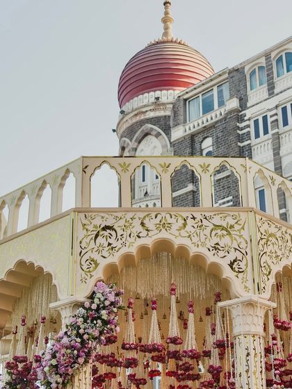 The grand mandap at the Taj Mahal Palace, perfectly framed against the hotel's iconic dome, a testament to our ability to work with and enhance landmark venues.