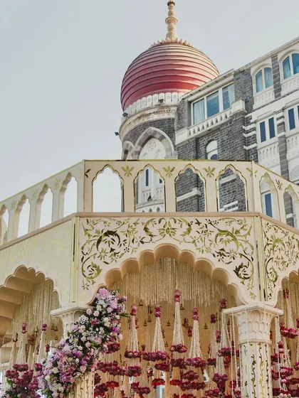 The iconic dome of the Taj Mahal Palace in Mumbai, framing a magnificent mandap. We are experts at integrating stunning architectural landmarks into our wedding designs.