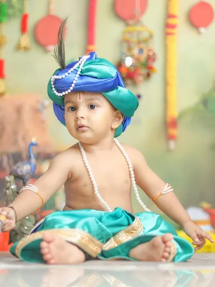 The intricate details of the costume and the baby's innocent expression make this a captivating portrait.